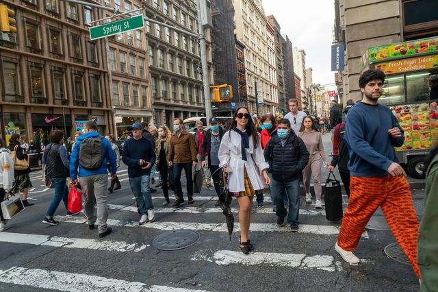 New York CIty - pedestrians crossing the street, some inmasks
